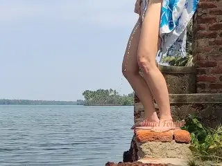 Shameless Tourist Girl Pissing on the Public Waterfront taking off her Swimsuit.