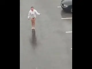 Dancing in the Rain with Wet White Shirt on a Busy Parking Loot