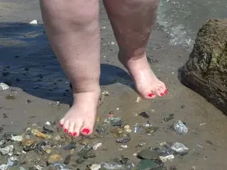 Fat Bare Legs with Red Pedicure Walk along the Bank of the River, Fetish.