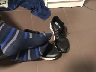 Male Shoeplay in Striped Socks and different Sneakers and Watching a Movie