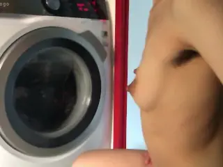 PETITE ASIAN TEEN W HAIRY ARMPITS DARK NIPPLES IGNORES YOU, JUST WATCHES WASHING MACHINE.