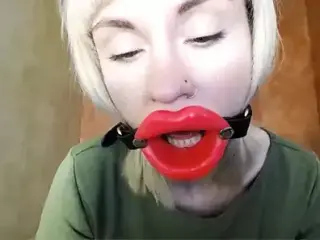 Zooming in red lips open mouth gag for dildo-blowjob.