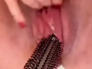 Horny American BBW fucks pussy with hairbrush until creamy