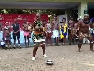 Busty African girl and fat guy doing some sort of show