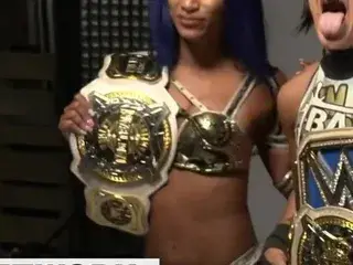 WWE - Sasha Banks and Bayley posing with the Tag Team titles