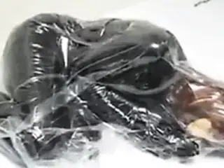 Girl with Rubber Mask in Vacuum Bag