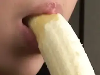 Beautiful Japanese girl sexily eating a banana