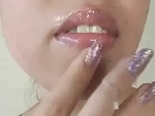 Japanese girl smearing cum-like cream on her mouth