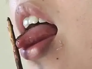 Japanese girl licking chocolate off a Pocky