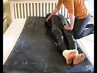 tied guy in pvc made to cum in his catsuit