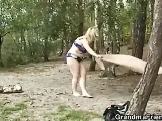 Flabby granny gets double dicked near the lake