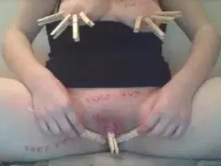 Slut clamps her nips and clit and slaps self