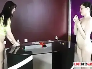 Two pretty girls play a strip air hockey game