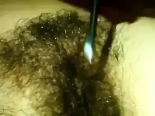 Wife grooming her hairy pussy