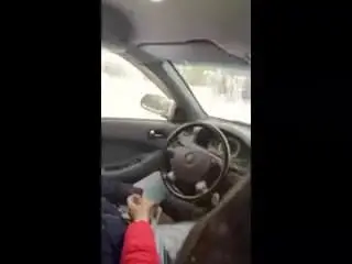 talking on the phone with one and holds the other cock