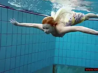 Blonde in a dress in a pool