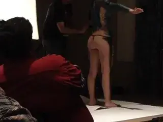 Girl getting body painted.