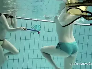 Girls swimming underwater and enjoying eachother