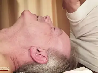 Old man gets oil massage from two beautiful teen girls