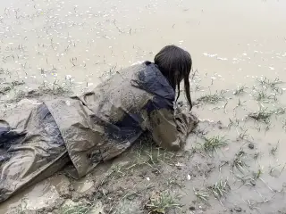 Muddy fields, rain suit in the rain