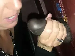 Wife sucks 2 BBCs at the gloryhole