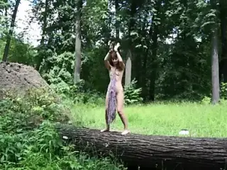 Nude dance on felled tree