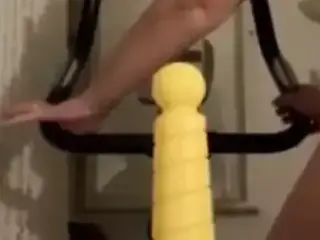 Mature with anal dildo while on bike