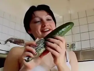 Small titted German chick sucking a cock and playing with a cucumber