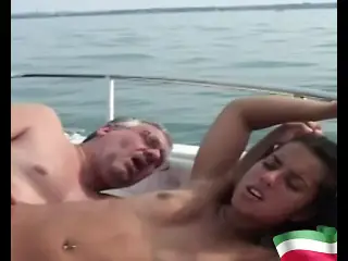 A young brunette gets fucked by an old pig on a boat