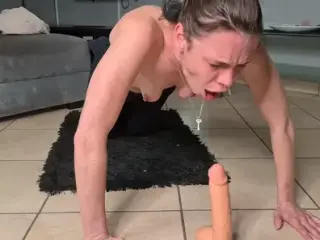 Slut-deep-throat gags herself with a dildo.