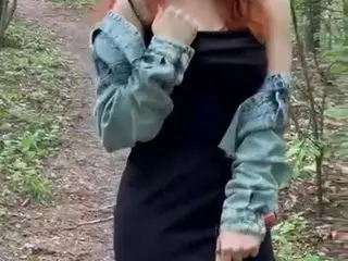 Sexy redheaded pussy walks through the woods almost naked