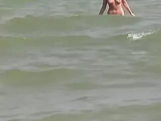 Hot German blonde rubbing her moist pussy on the beach