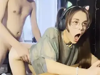 Schoolgirl with ponytails fucks and plays a video game