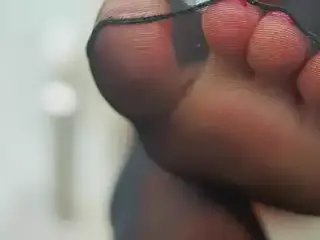 feet in pantyhose and saliva close-up