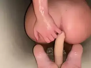 Dildo in the shower of a beauty with a tight pussy.