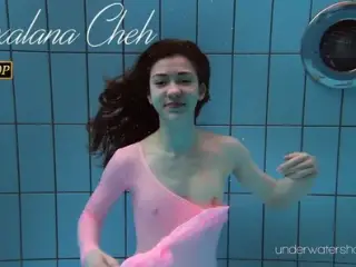 Roxalana Cheh wearing pink dress in the pool