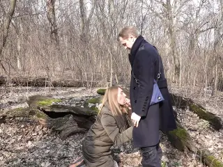 In the forest, a girl got on her knees and start sucking cock