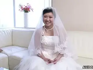 Japanese girl in a wedding dress Emi Koizumi takes a hard cock in her mouth uncensored.