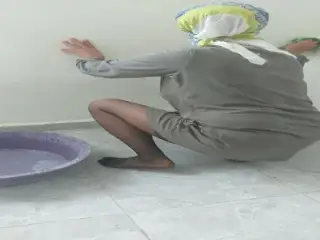 Hijab woman cleaning kitchen