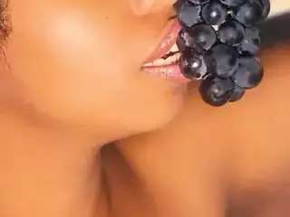 Sexy mouth ebony pating with some grapes