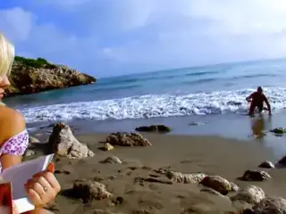 Blond woman fucks an unknown man on the beach