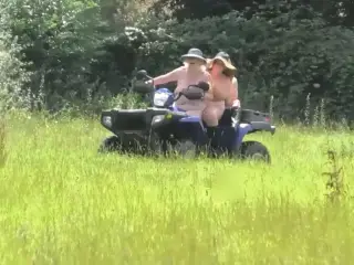 Crazy Naked Matures in floppy hats on a Quad bike