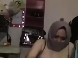 Hot girl in a hijab plays with her toy