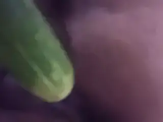 Wife plays with cucumber