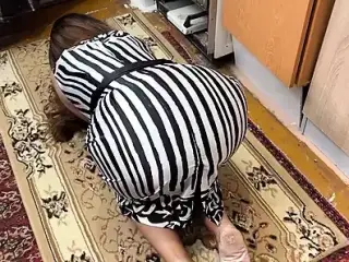 On the floor, a housewife is on her knees and feels a dick in her ass when she has anal sex