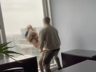 MILF boss fucked against her office window