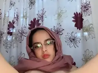 Arab with hijab on stretches using anal toys